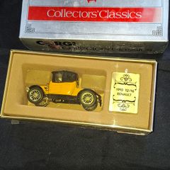 Corgi Collectors Classics 1910 Renault 12/16 scale model car. The set features a 1:43 scale diecast model in a yellow and black color scheme. It comes in its original box with a decorative gold-colored plaque