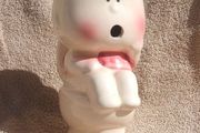 A vintage novelty money box in form of a young child sitting on a toilet (1930s to 1960s)