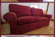 Living room / lounge couch in dark burgundy red