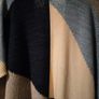 Monsoon Colourblock Knit Poncho. The design features an abstract, geometric color-block pattern with shades of blue, grey, and cream and Navy. Image 6