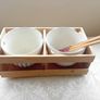 Noodle Bowls Japanese Flower  Set of two noodle bowls boxed in a wooden crate with 2 pairs of chop sticks. These are a great idea for a new home or perhaps the kids setting our on their own. Attractive on the table giving a genuine oriental feel. Weight ( Image 2