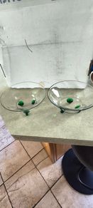 2 clear glass bowl with virbant green glass feet .