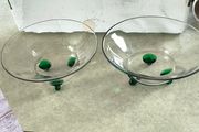 2 clear glass bowl with virbant green glass feet .