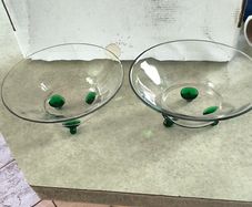 2 clear glass bowl with virbant green glass feet .