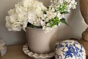 Beige pot with faux flowers