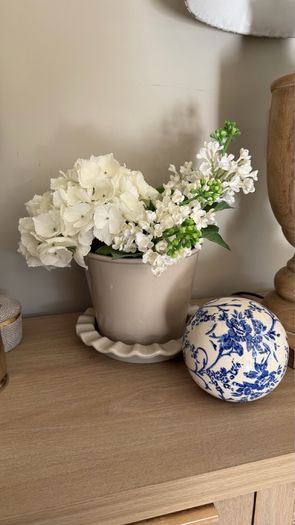 Beige pot with faux flowers