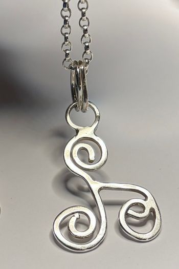 Sterling silver Triskele pendant on 18 or 20 inch chain.
