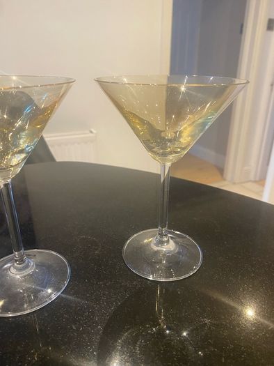 Set of four amber and plain glass martini or cocktail glasses
