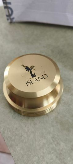 2 Papper Weight , Brass Papper Weight marked ISLAND 12.00 euro. Cleare Risen Tile Papper Weight.with black velvet on the back.10.00 euro.