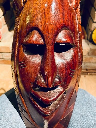 Two carved tribal masks