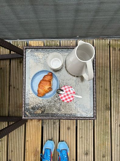 Brown rattan outdoor table and rocking chair