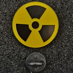 Radiation warning symbol, pin back badge.