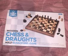 Boxed wooden chess board, prices and checkers set