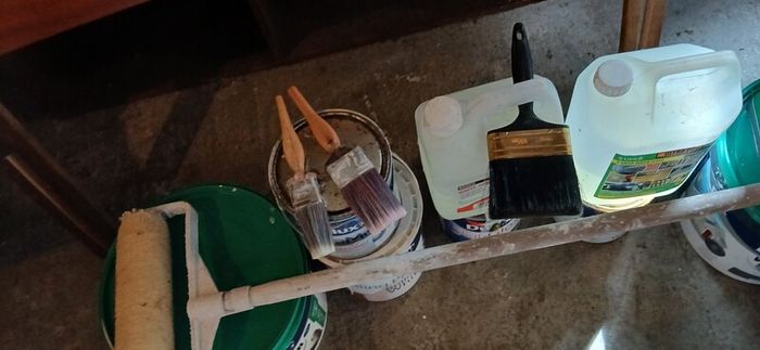 a selection of paint and a paint roller and some good paint brushes