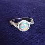 A beautiful 925 silver ring with a white lab opal surrounded by shining cubic zirconia. Image 2