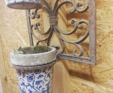 Vintage wrought iron plant hangers. Porcelain containers