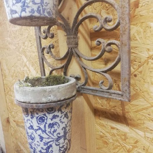 Vintage wrought iron plant hangers. Porcelain containers