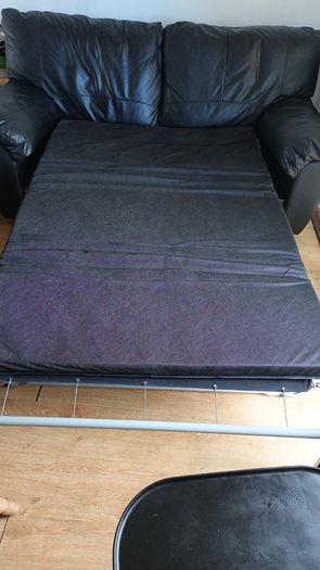 Black leather two-seater sofa-bed