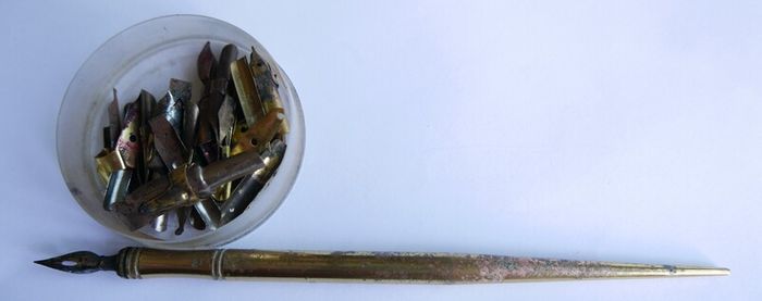Vintage dip pen with collection of assorted nibs