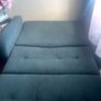 Grey fabric sofa bed with large storage compartment. Image 3