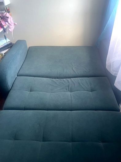 Grey fabric sofa bed with large storage compartment.