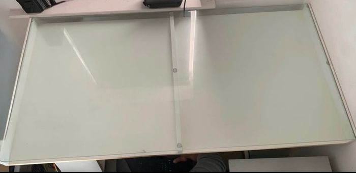 Study/ Office table Used but in great condition This is a modern minimalist table with a sleek white finish and a glass top
