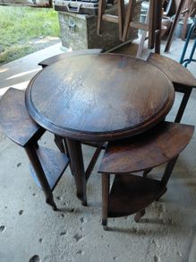 Vintage round nest of tables central round table four pie slice nesting tables tucked underneath