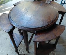 Vintage round nest of tables central round table four pie slice nesting tables tucked underneath
