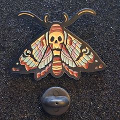 Skull/butterfly , pin back badge.