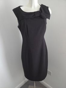 Never Worn. Size L. Fits 10-12. Soaked Black Dress with gorgeous, oversized bow on shoulder.