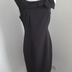 Never Worn. Size L. Fits 10-12. Soaked Black Dress with gorgeous, oversized bow on shoulder.