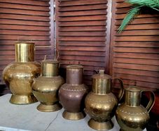 Antique brass & copper graduated collection of lidded dairy pitchers