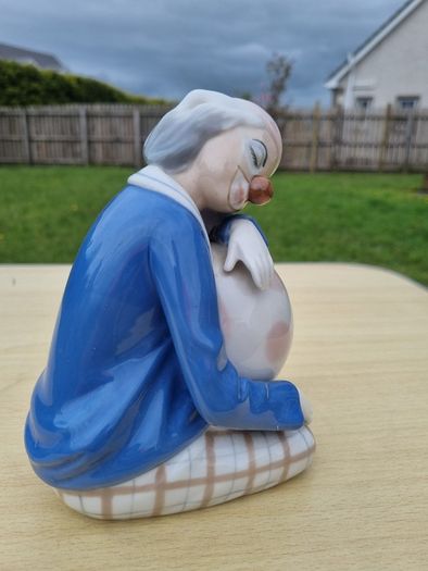 Porcelain sleeping clown with ball