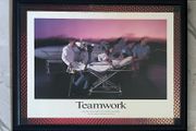 Framed Motivational Teamwork Photo showing ambulance crew/ hospital transporting patient with airplane in the rear