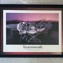 Framed Motivational Teamwork Photo showing ambulance crew/ hospital transporting patient with airplane in the rear