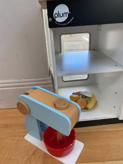 kids play kitchen by Plum with wooden food accessories