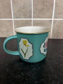 Brand Mew Mug with a Gold Rim and Floral Designs