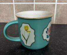 Brand Mew Mug with a Gold Rim and Floral Designs