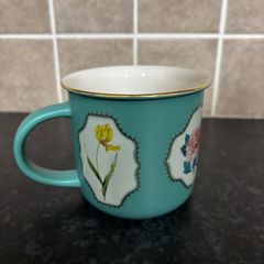 Brand Mew Mug with a Gold Rim and Floral Designs