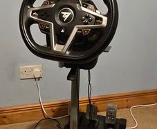 Thrustmaster T248 Racing Wheel and T3PM Pedal Set, complete with a sturdy folding metal wheel stand.
