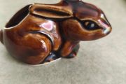 Brown rabbit majolica statue.