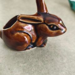 Brown rabbit majolica statue.
