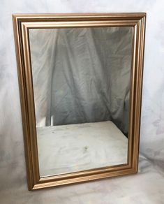 Mirror with frame in antique gold