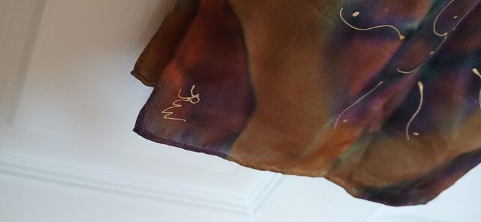 Hand painted, 100% silk scarf featuring a hand-rolled hem and custom metallic gutta detailing.