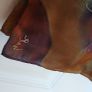 Hand painted, 100% silk scarf featuring a hand-rolled hem and custom metallic gutta detailing. Image 2