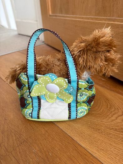 Dog stuffed animal in bag