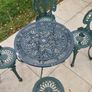 Cast metal garden table and four chairs Image 2