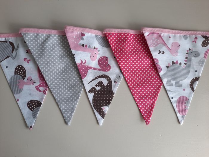 Dinosaur buntings . Blue and pink