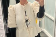 cream jacket and black skirt
