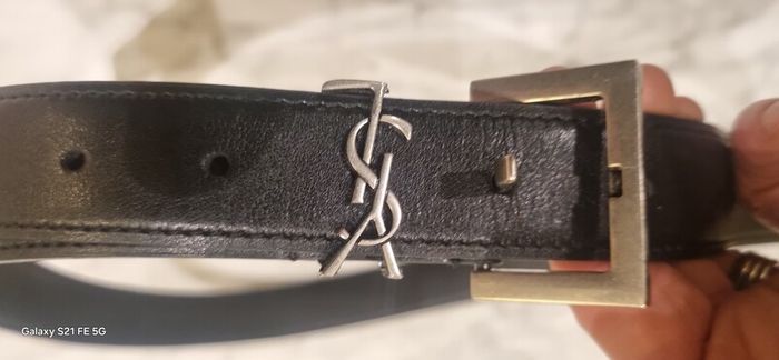 Black leather belt in the style of designer